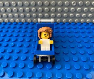 newborn baby with lots of hair sitting in a pram