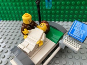 Dad comforting Mum during an emergency c-section.