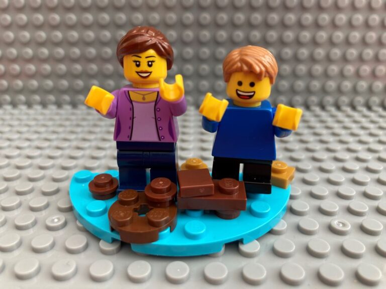 Mother and child jumping into a muddy puddle together