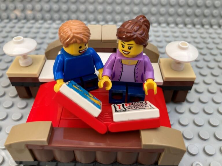 Mother and child reading on the bed together.