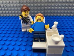 Child sitting in a dentist chair with a wobbly tooth