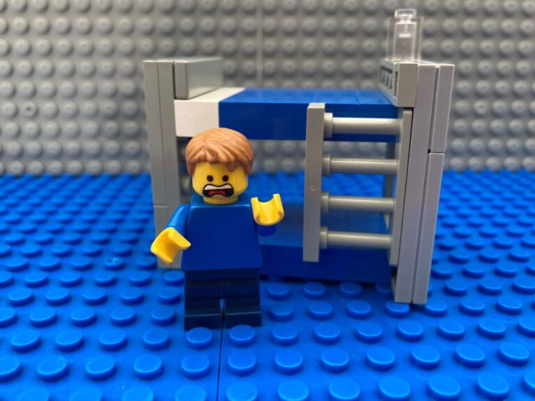 Child standing by his bed having lost his wobbly tooth