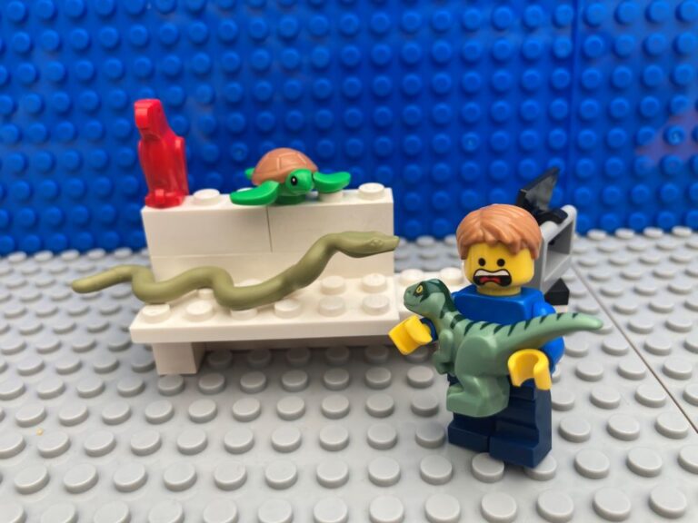 snake and dinosaur on shelf in a toy shop