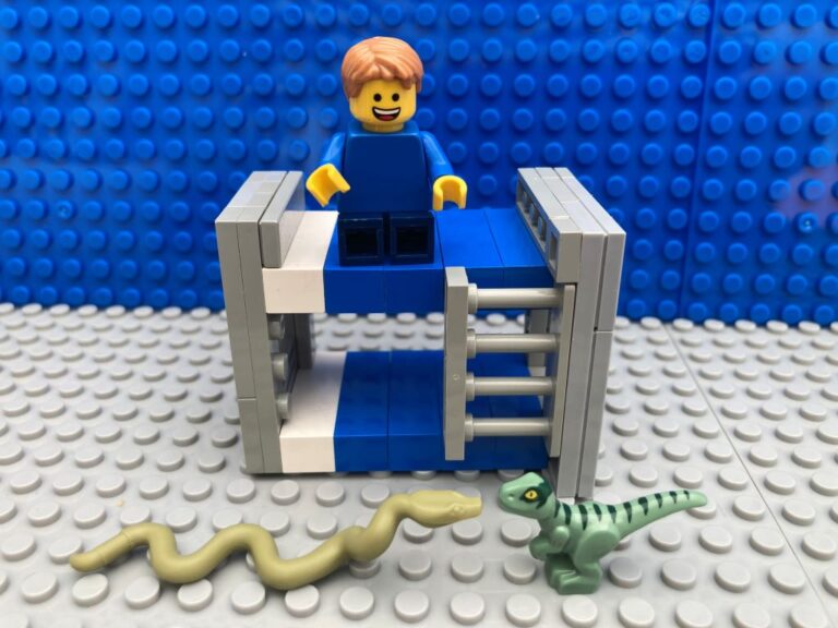 toy snake and dinosaur in battle by child's bed