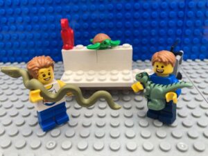 children getting a dinosaur and snake in a toy shop