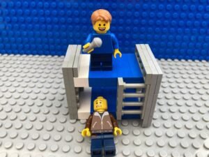 Child singing loudly while Dad is slumped on the floor