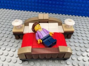 Mum asleep on her bed after singing bedtime songs to her children