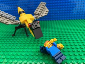 Dad and Child collapsed on the floor with angry wasp looming over them