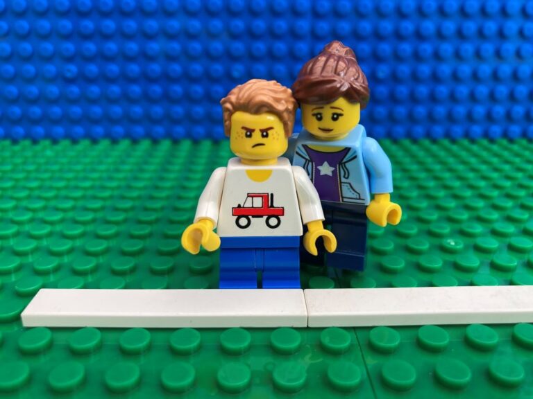 Mum helping a child who has lost a race at sports day