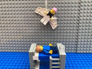 Tooth Fairy taking a child's tooth from under their pillow