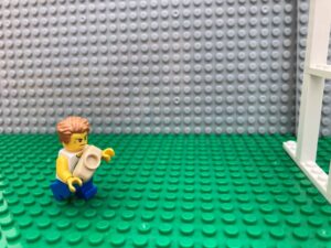 excited child running with rugby ball towards posts