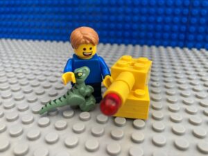 child leaving shop with dinosaur toy and tank toy