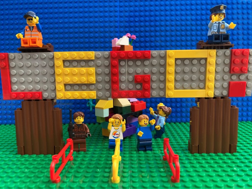 family outside Lego sign