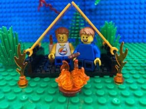 family sitting in a tent by a bonfire