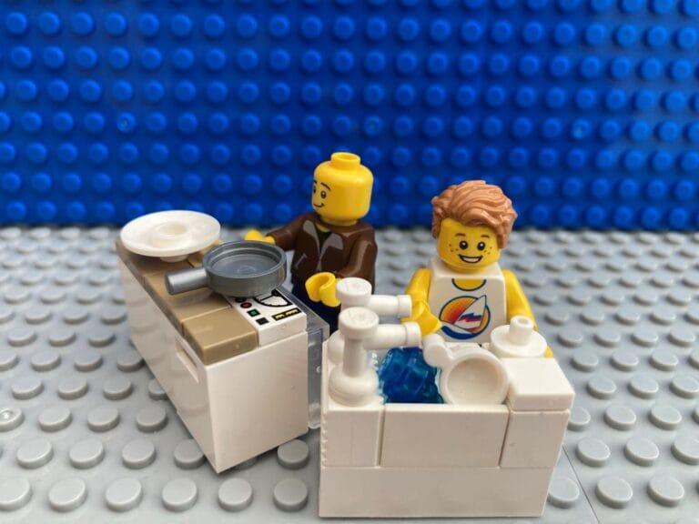 Dad teaching child how to do kitchen chores