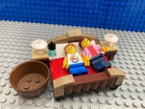 Mum and child lying in bed suffering from a sickness bug