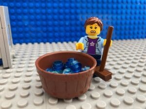 Mum with mop and bowl of water looking horrified