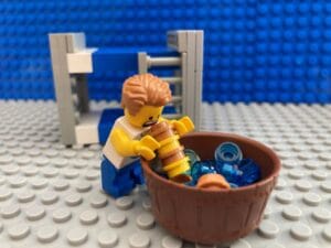 Child hunched over a sick bowl