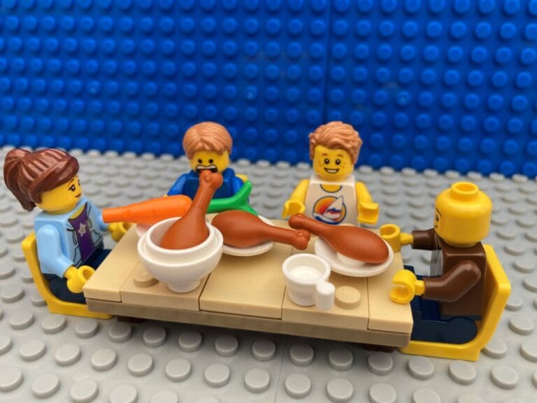 Mum, Dad, 2 children sitting down for a family dinner together at the table