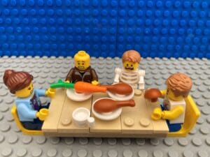 family sitting at the table with a pretend skeleton