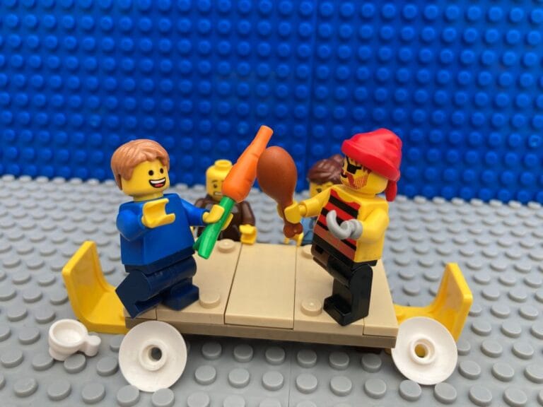 pirate child and pirate battling with a carrot and chicken drum stick at the table