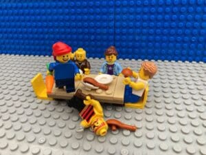 Pirate child standing on the table with defeated pirate lying on the floor