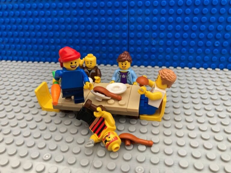Pirate child standing on the table with defeated pirate lying on the floor
