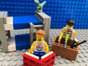 child reading while a burglar steals toys behind him