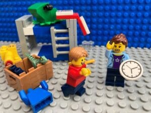 Child dancing while Mum holds clock and looks worried