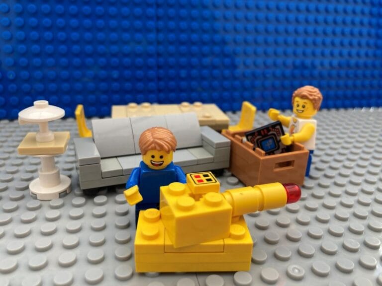 Children putting screens in a box and playing with toys