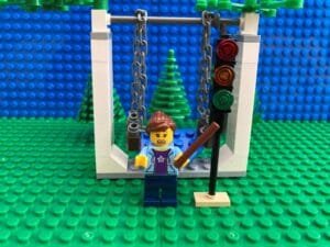 Mum pointing to a traffic light with a stick