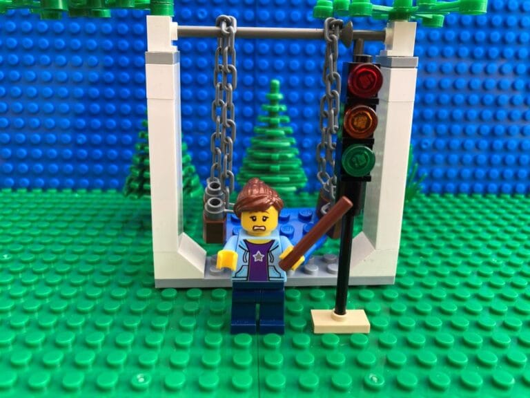 Mum pointing to a traffic light with a stick