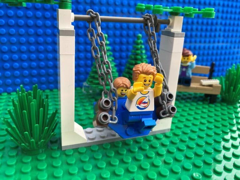 Child jumping on a swing without holding on