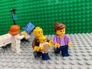 Mum and Dad walking out of hospital with a newborn baby, struggling to find any newborn bonding time