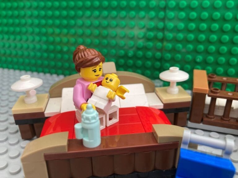 Mum bonding with newborn while feeding him in bed