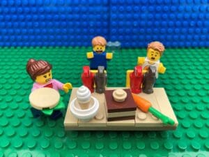 Mum feeding the birds at dining room table while children look on horrified