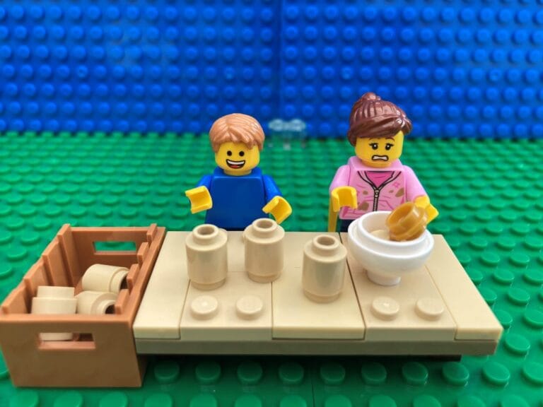 Mum and child making homemade kid friendly bird feeders at dining room table