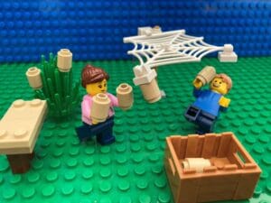 Mum and child hanging up their homemade bird feeders