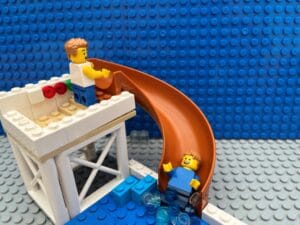 Two children going down a water slide