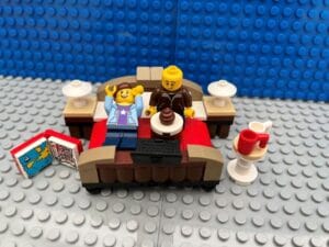 Parents eating food in bed and watching telly on their kid-free weekend