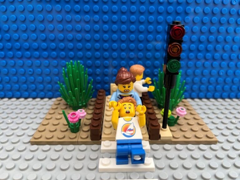 Child starting to cross the road while Mum jerks him back.