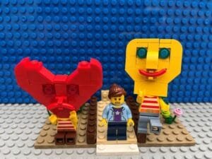 Heart character sitting with head in hands. Head character dancing happily as Mum makes a decision about child crossing the road