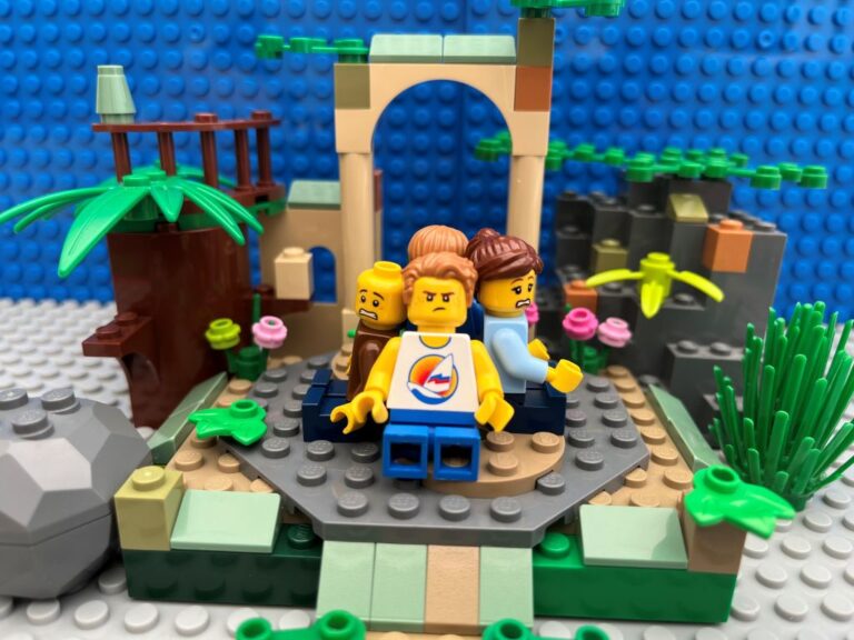 A family sat down in the ruins of an old castle. Everyone is sitting with their backs to eachother because nobody wants a happy family photo expect Mum.