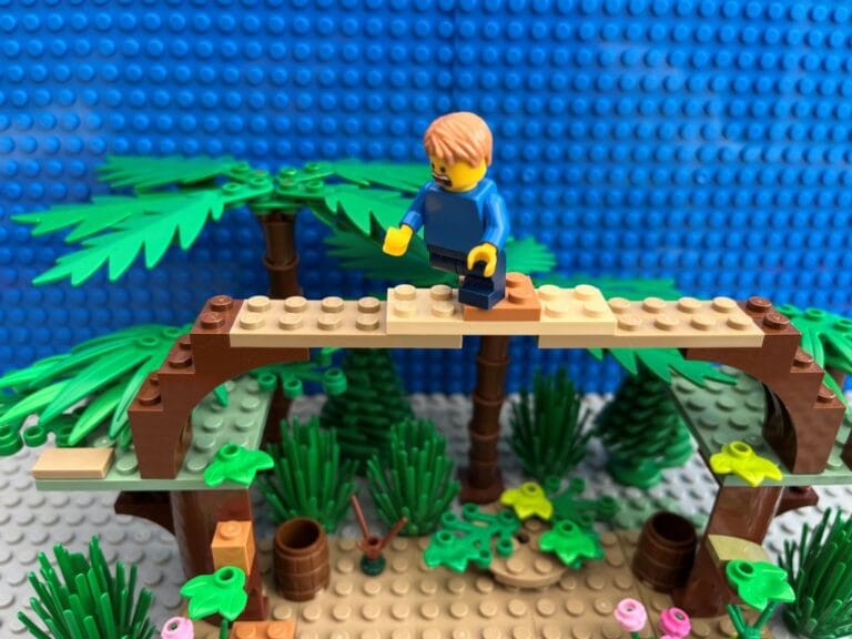 Child walking across a balancing obstacle up in the trees