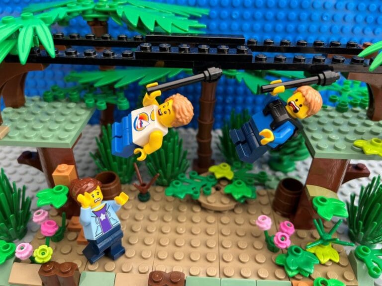 Scared mum watching from the ground as her two boys swing from a zip-line up in the air