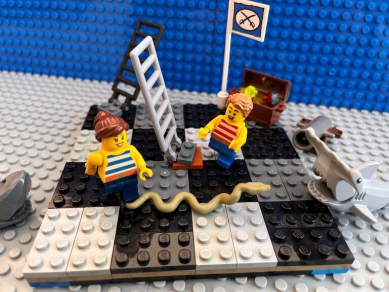 Mum and older child playing snakes and ladders board game