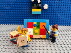 Mum helping child with homework by creating a colourful homework chart