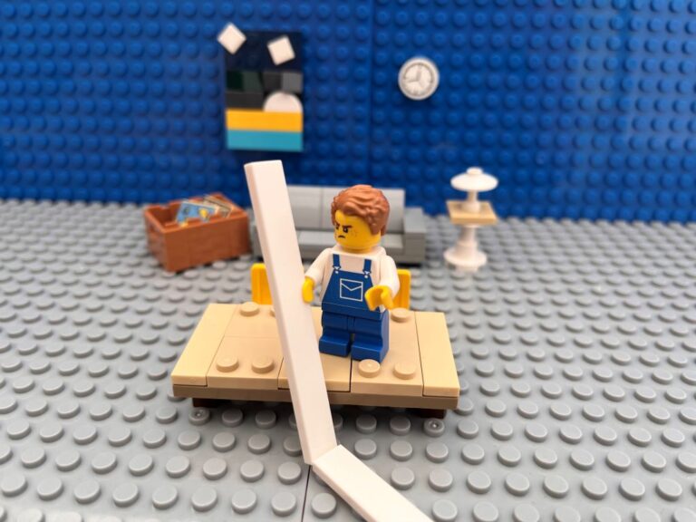 Child standing on a table holding a list of everyday chores that is running off the table onto the floor