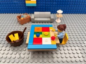 Mum working on a new chores chart at a table