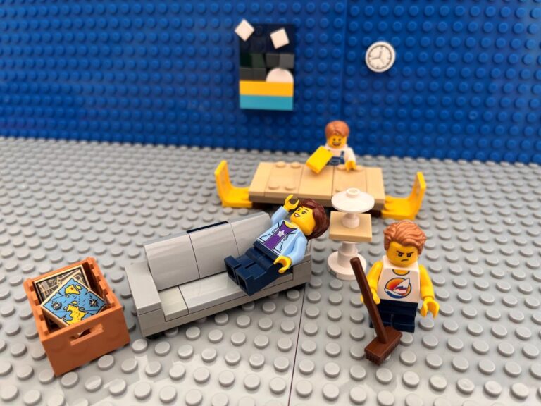 Mum resting on the sofa while two children clean up around here